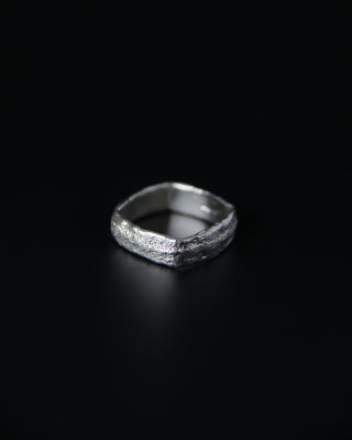 sterling silver textured square band ring on a black background