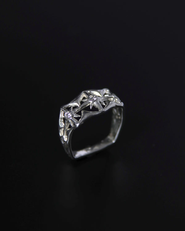 Moissanite Silver ring with north star design on a black background