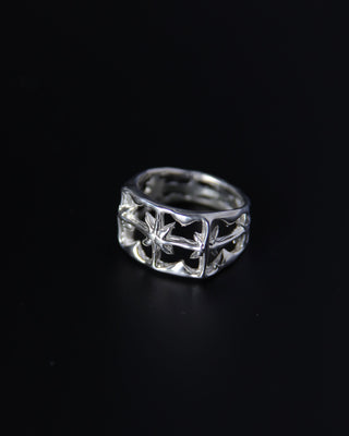 Silver ring with intricate celestial design on a black background