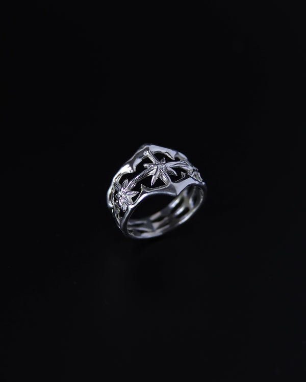 Sterling silver ring with celestial design on a black background