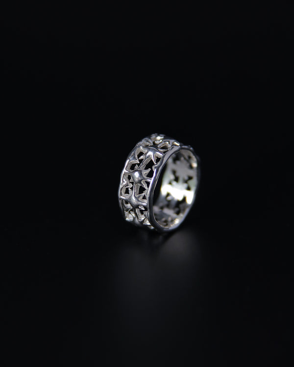Silver ring with intricate star design on a black background